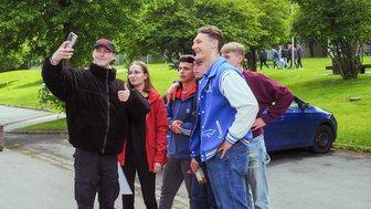 Eine Gruppe von Schülerinnen und Schüler fotografiert sich selbst mit dem Handy